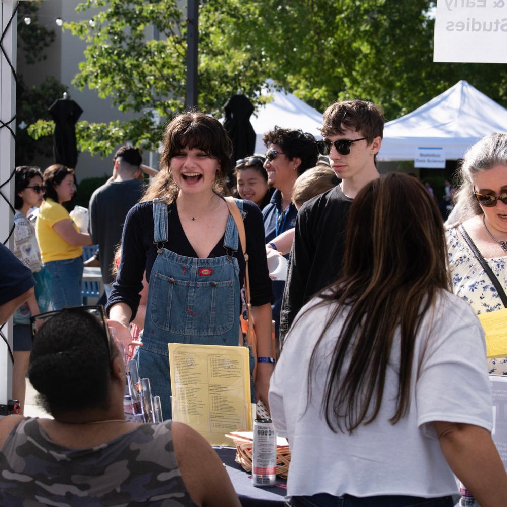 Students at a major booth at an event called Transfer Day